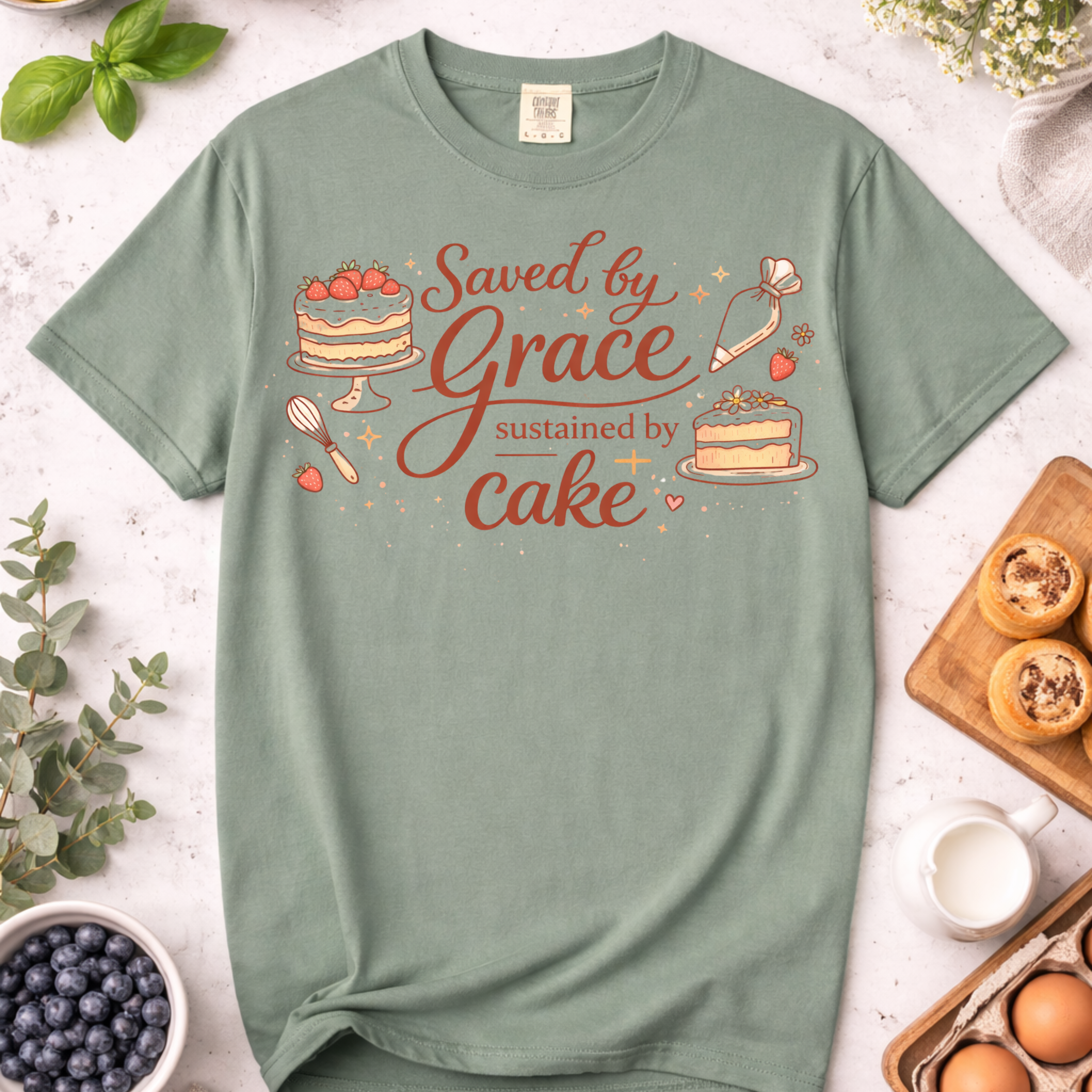 Saved by Grace, Sustained by Cake T-Shirt — Funny Christian Baking Tee